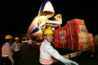Airport workers load up a cargo plane from China Airlines, Taiwan�s largest air carrier, at Taiwan�s international airport in Taipei July 19, 2006. 