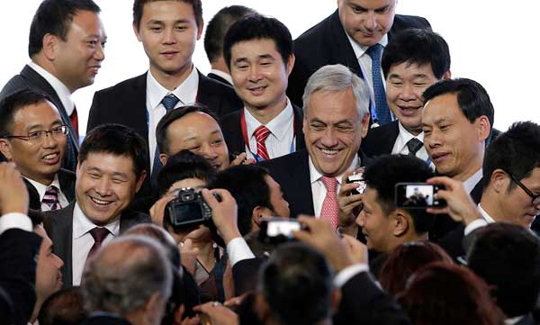 President of Chile Sebastian Pinera smiles as he is surrounded by Chinese delegates waiting to take photographs with him, after his speech at the Asia-Pacific Economic Cooperation CEO Summit in Bali, Indonesia, on Sunday. Wong Maye-E /AP Xi confident of boost to China-ASEAN ties
