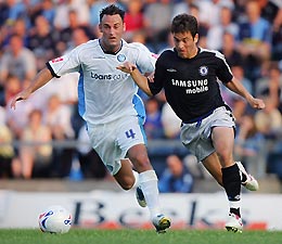 Chelsea's Joe Cole competes for the ball with Stefan Oakes (L) of Wycombe Wanderers during their pre-season friendly soccer match at the Causeway stadium in Buckinghamshire, central England, July 13, 2005.