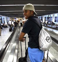 Brazil's striker Robinho walks through the Frankfurt International Airport before his team's departure from Germany late June 30, 2005.