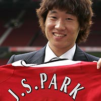 South Korea's Park Ji-sung holds a Manchester United shirt after signing with Manchester United at Old Trafford, Manchester, north England, July 14, 2005. 