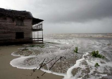 Waves flood a house in the evacuated town of Boca de Galafre, in Pinar del Rio province, Cuba October 21, 2005.