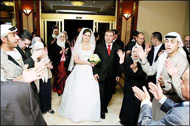 Ashraf Mohamed al-Akhras and his bride Nadia al-Alami arrive at Radisson SAS hotel's Philadelphia hall at the start of their wedding party before an explosion hit the hotel in the heart of Amman. The bride and the groom both lost their fathers to the deadly blast that ripped through their wedding reception at the luxury hotel. The couple were also wounded in the explosion. 'I lost my father and my father-in-law and I saw many other dead. This is a horrible crime. The world has to know this has nothing to do with Islam,' Khaled told state television from his hospital bed.(AFP)