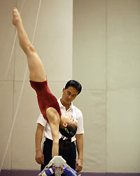 Chen Yixin and her trainer Wang Qunce practice at Beijing's National Gymnastics Centre November 9, 2005.