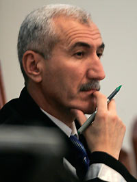 Presiding Judge Rizgar Mohammed Amin listens to testimony as the trial of Saddam Hussein resumes in Baghdad in this December 21, 2005 file photo.