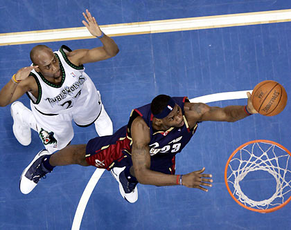 Cleveland Cavaliers guard Lebron James (bottom) is fouled by Minnesota Timberwolves center Mark Blount as he attempts a lay-up during the first half of their NBA game in the Target Center in Minneapolis February 8, 2006.