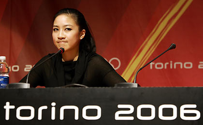 Figure skater Michelle Kwan of the United States listens to a question during a media conference after pulling out of the Torino 2006 Winter Olympic Games in Turin, Italy, February 12, 2006.