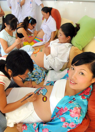 Paintings on pregnant woman's belly