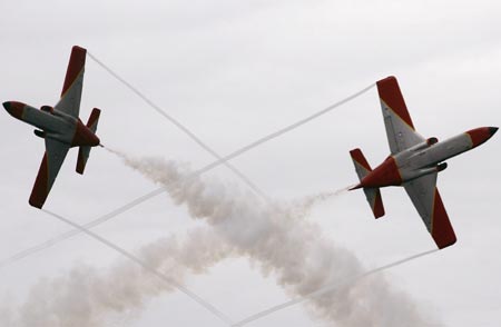 Members of the Spanish Air Force acrobatic group 'Patrulla Aguila' fly over Samil beach in Vigo, northern Spain during an aerial exhibition July 22, 2007. 