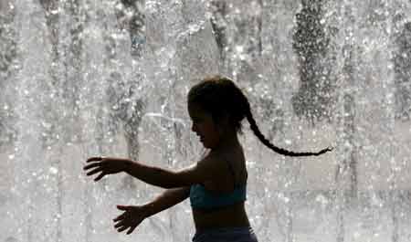 Girl plays in a fountain 