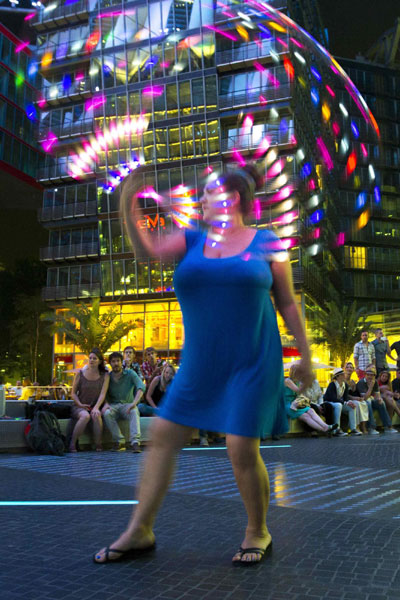 Women twirl LED-lit hula hoops in Berlin