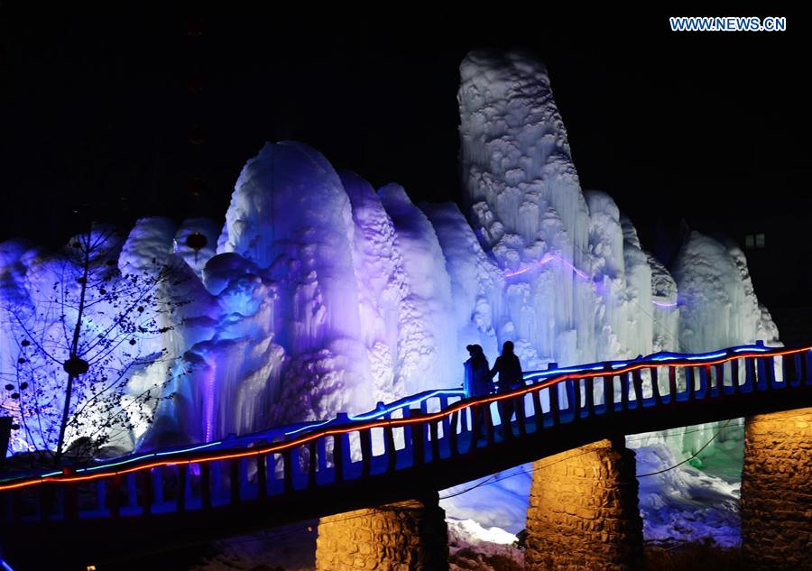 People visit frozen waterfall in N China