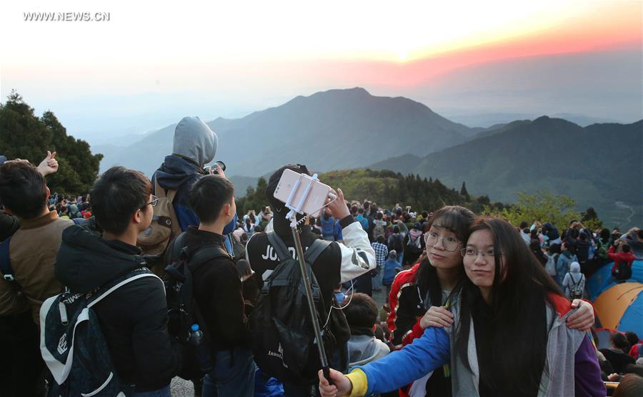 Tourists view sunrise at Hengshan Mountain scenic area in C China